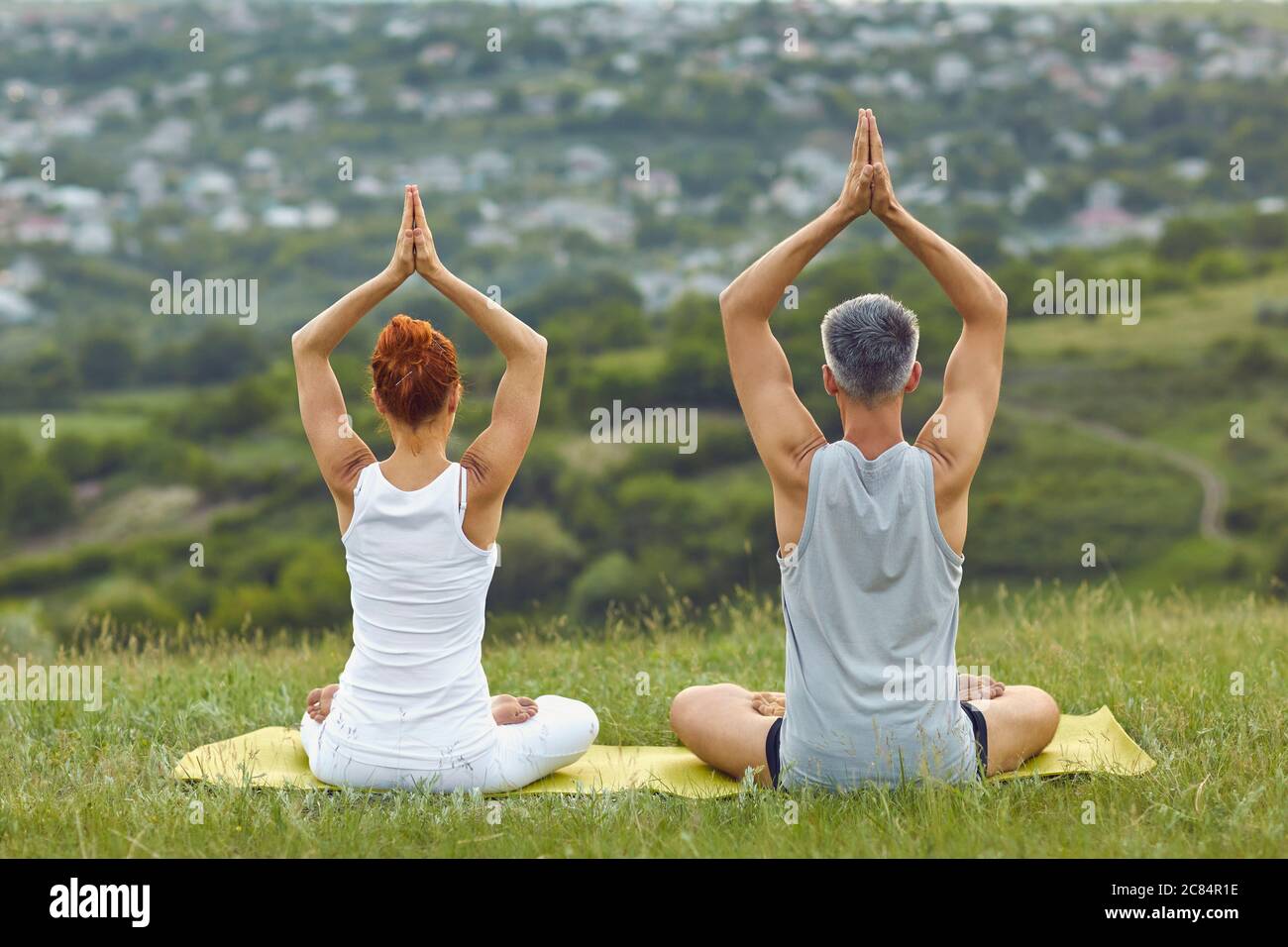 Anonymous couple meditating in ssummer spring nature Stock Photo