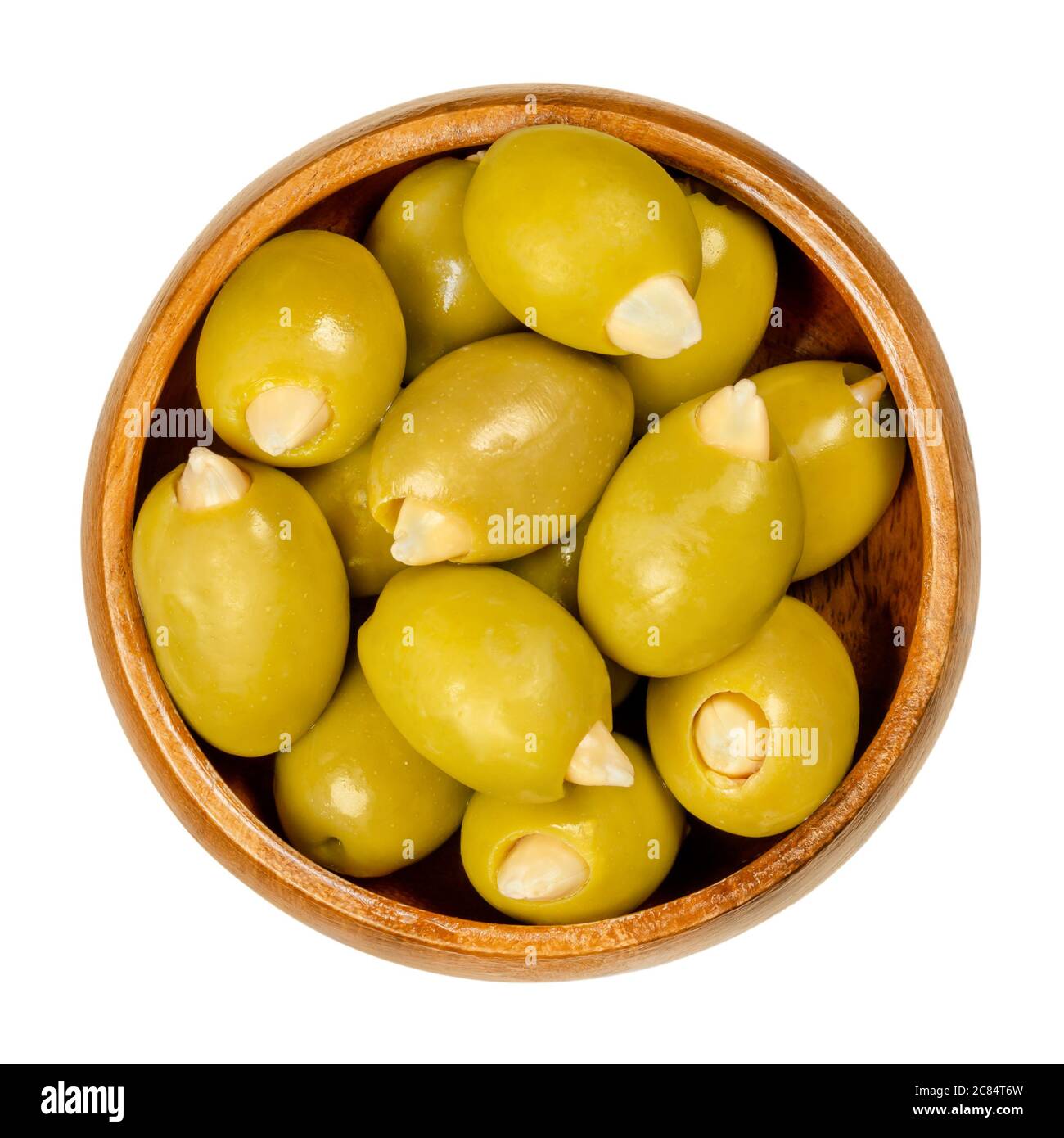 Almond stuffed green olives in wooden bowl. Big European olives, fruits