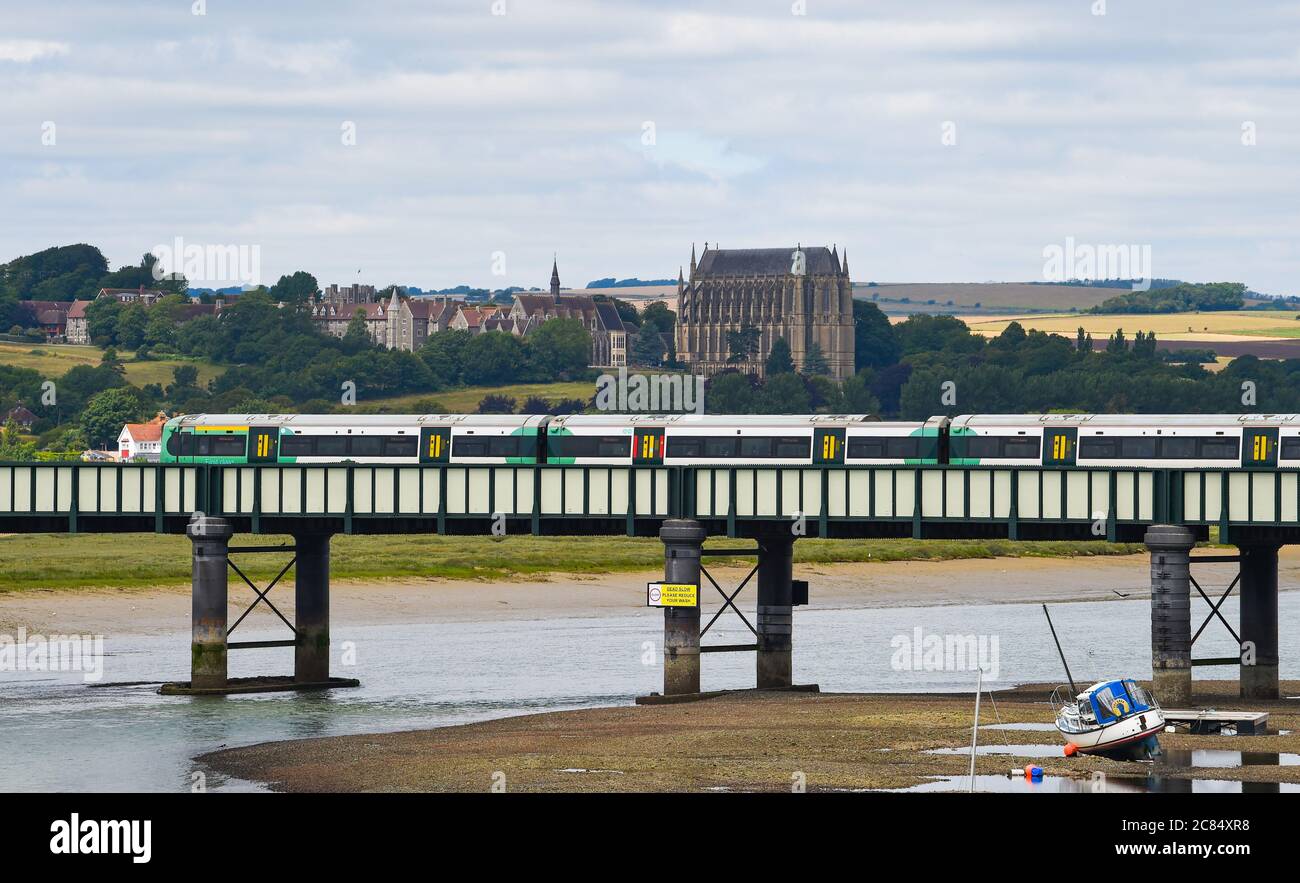 Southern Rail train crosses the River Adur at Shoreham-by-Sea with Lancing College in distance Stock Photo
