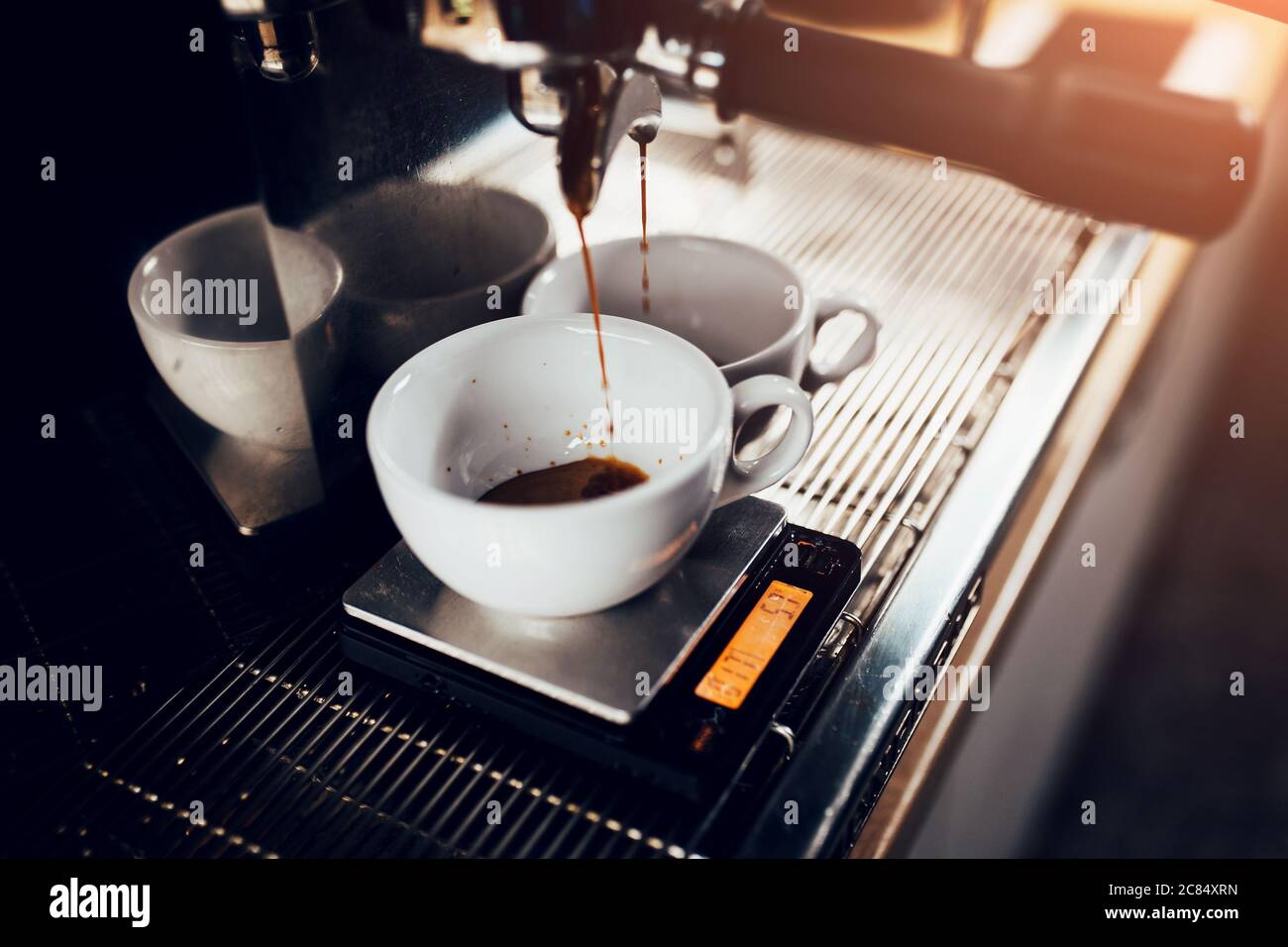 A professional barista transforms ground coffee beans into aromatic