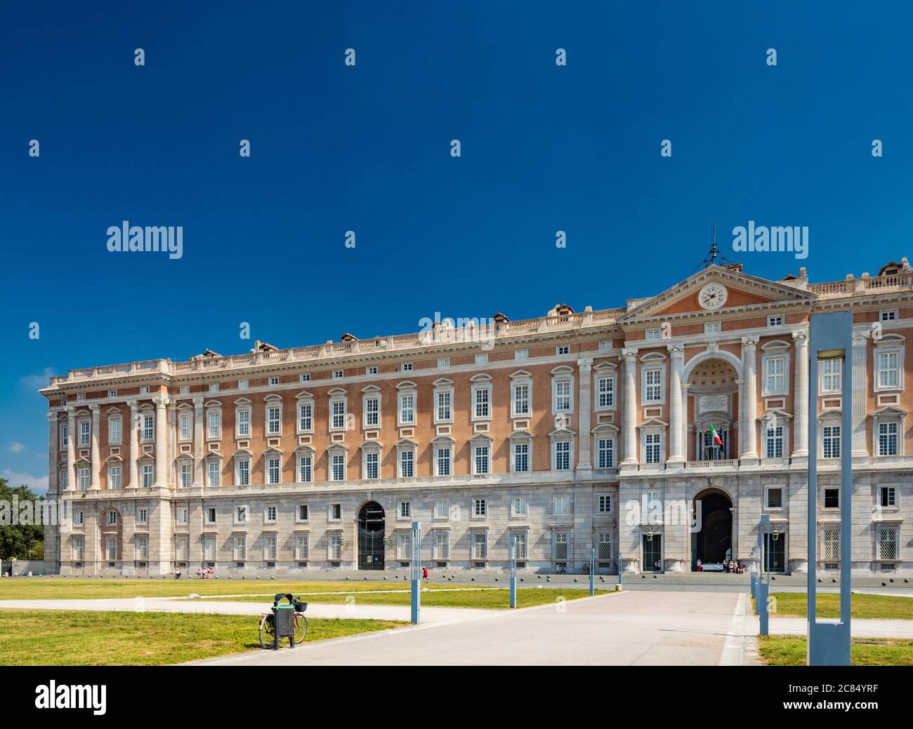 July 3, 2020 - Royal Palace of (Reggia di) Caserta - The facade of the majestic palace with the large avenue and the main entrance. Many windows, colu Stock Photo