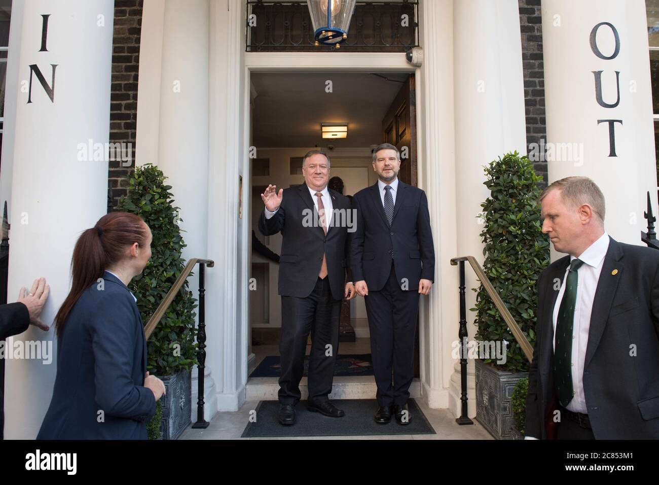 United States Secretary of State, Mike Pompeo (left) is greeted by Executive Director of the Henry Jackson Society, Alan Mendoza as he arrives at the In And Out Club in London to meet backbench MPs ahead of meetings with Prime Minister Boris Johnson and Foreign Secretary Dominic Raab. Stock Photo