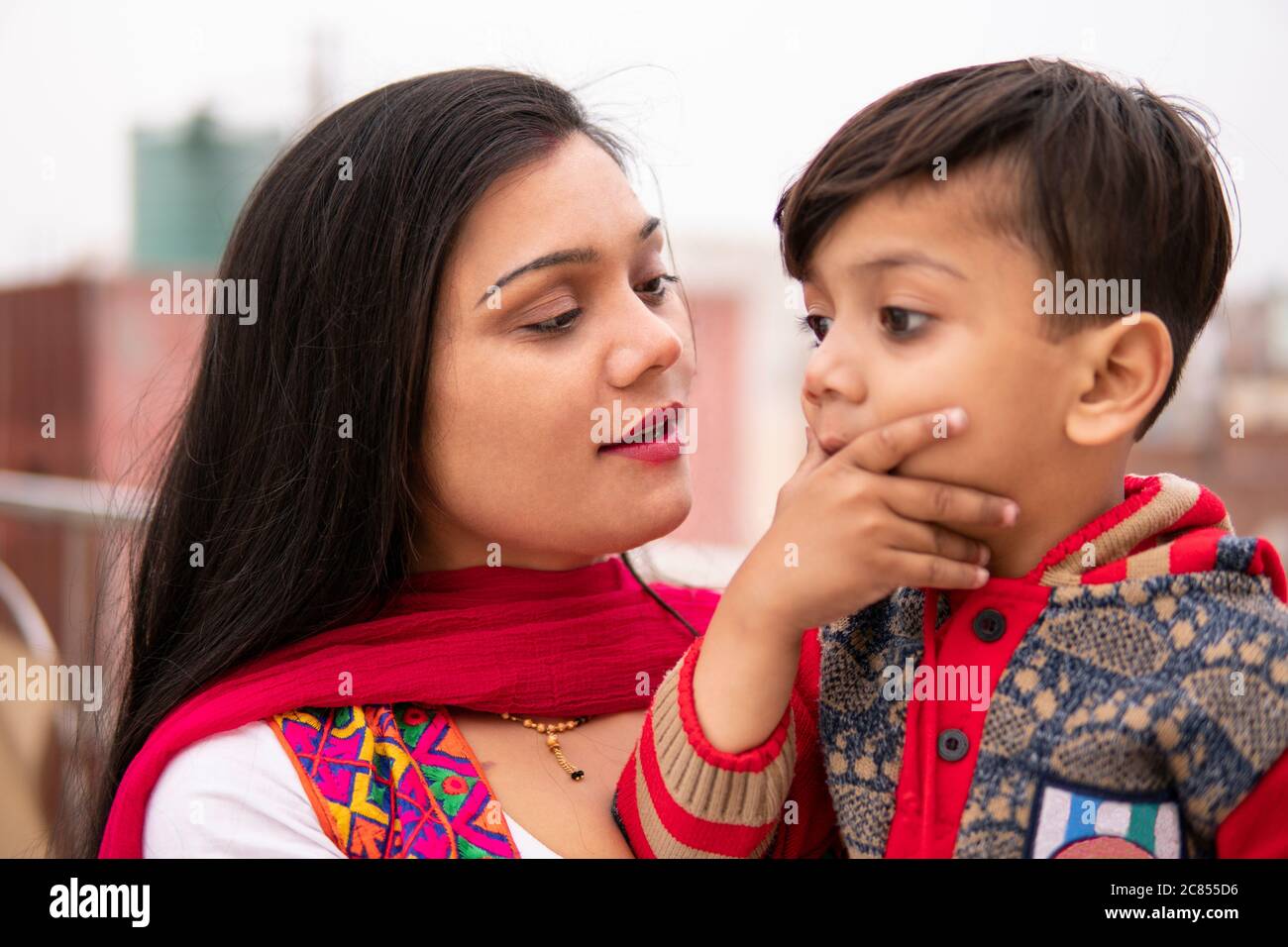 Beautiful, happy Indian young mother with her cut little son. She on ...