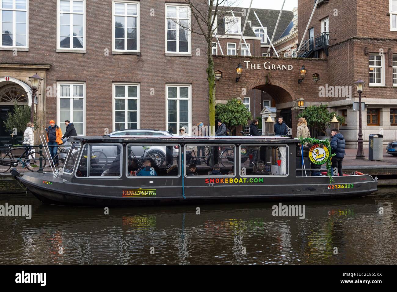 Amsterdam, Netherlands - January 15 2019: Passengers enjoy smoking cannabis on the Smoke Boat in the De Wallen Red Light District of Amsterdam. Stock Photo