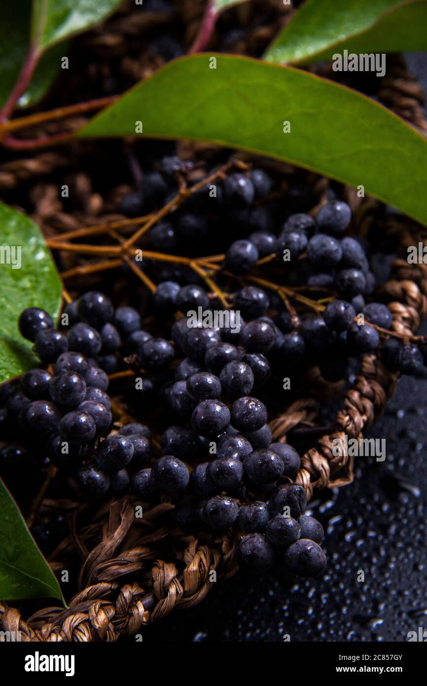 Raspberry clusters next to green and fresh leaves of plants with a ...