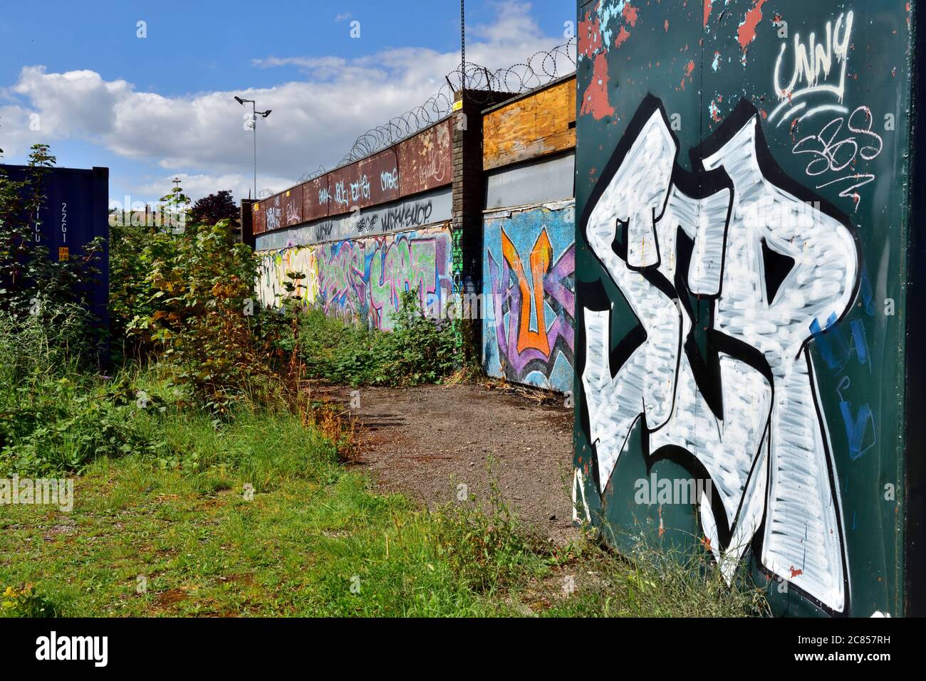 Derelict, abandoned buildings and shipping containers covered in graffiti Stock Photo