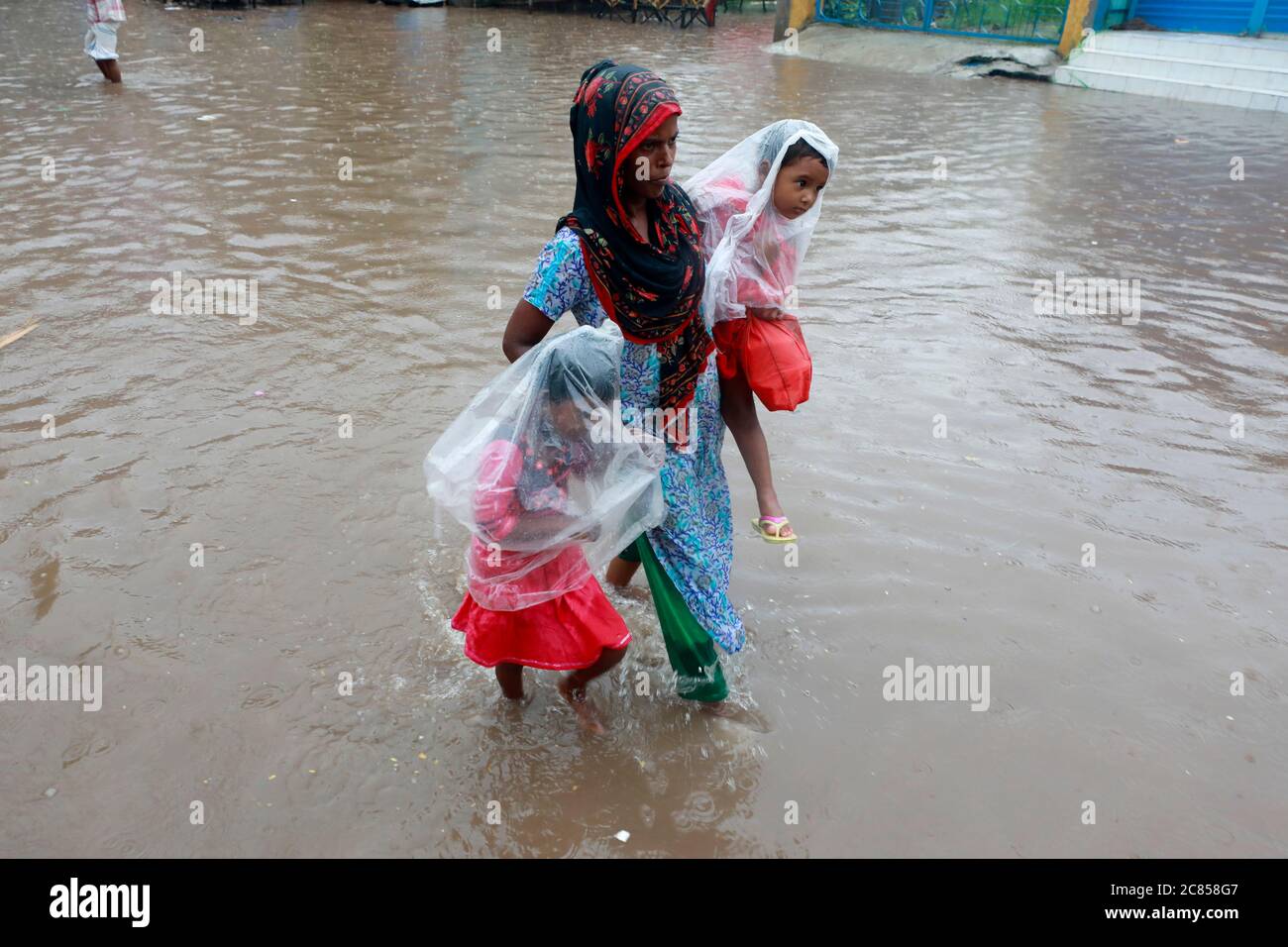 People walk through flooded street hi-res stock photography and images ...