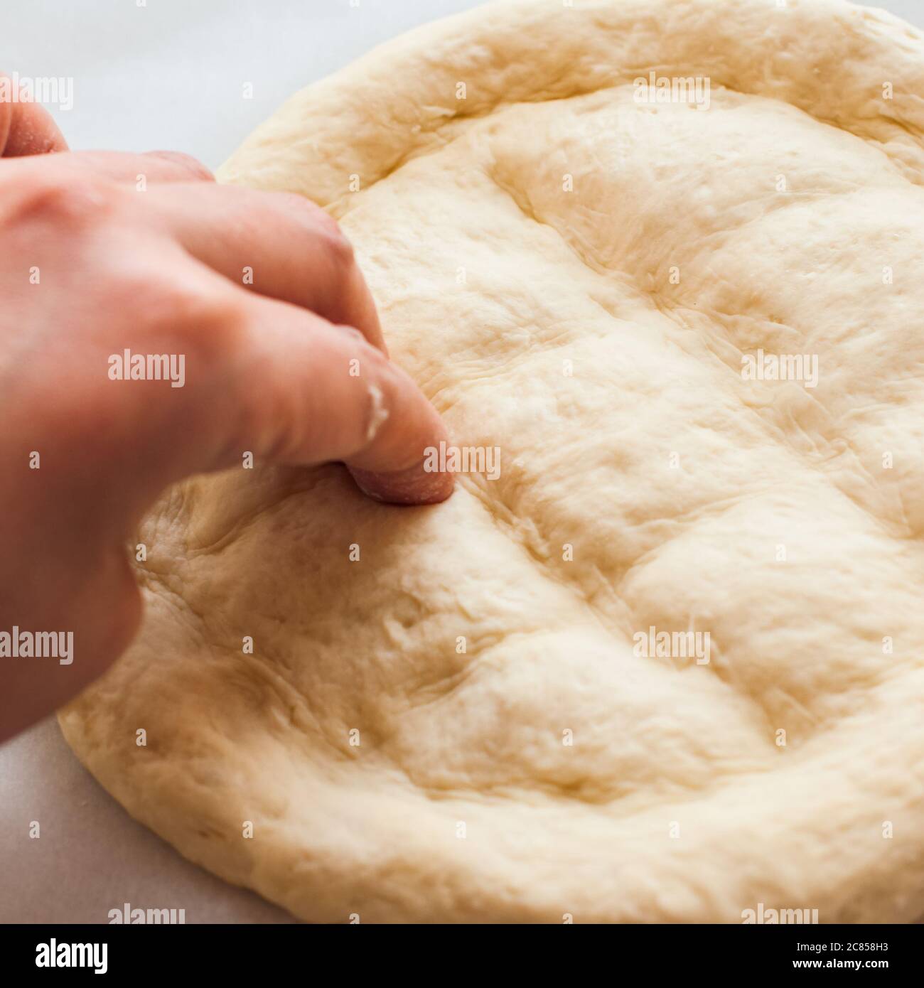 Round dough on a table, preparing ramadan pide. Stock Photo