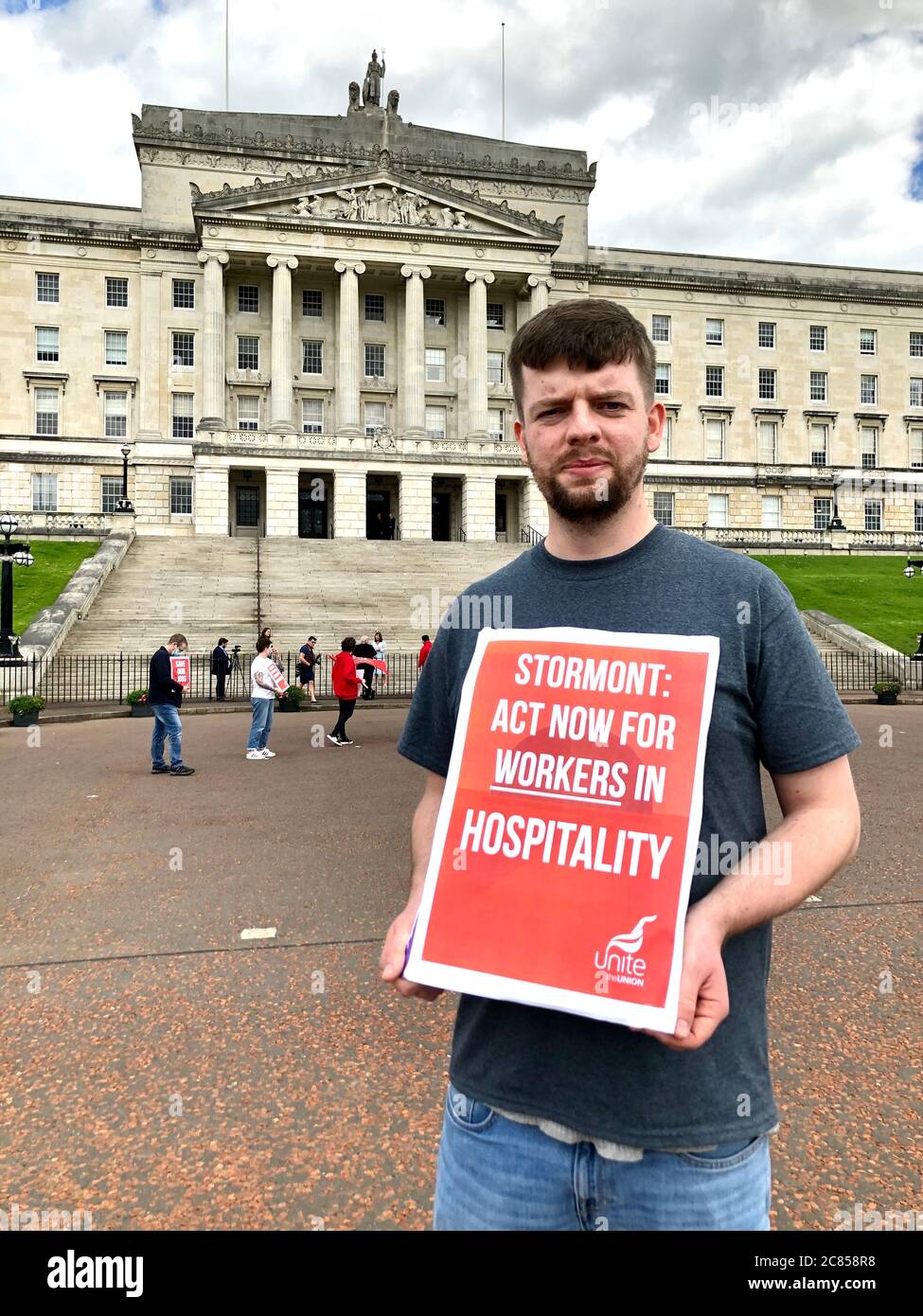 Neil Moore, Unite's hospitality and tourism organiser, joins a protest outside Parliament Buildings, Belfast. Hospitality workers have voiced concerns about employers using the job retention scheme to make 'opportunist lay-offs' and pay wages during statutory notice periods. Stock Photo
