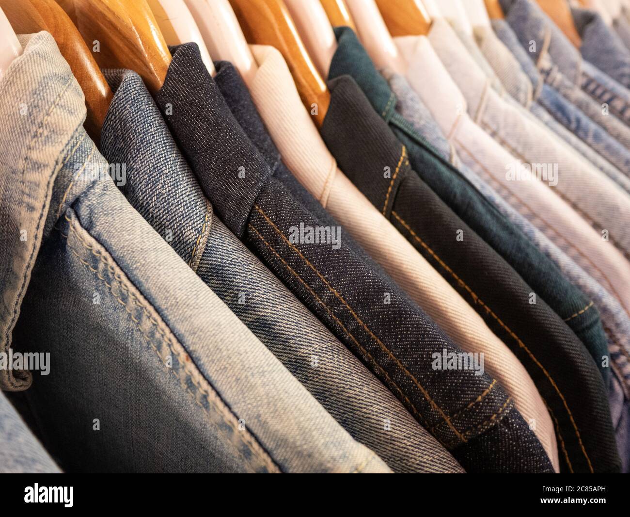 https://c8.alamy.com/comp/2C85APH/a-selection-of-denim-jackets-hanging-on-a-rail-illustrate-the-different-tones-and-textures-of-jean-fabric-available-2C85APH.jpg