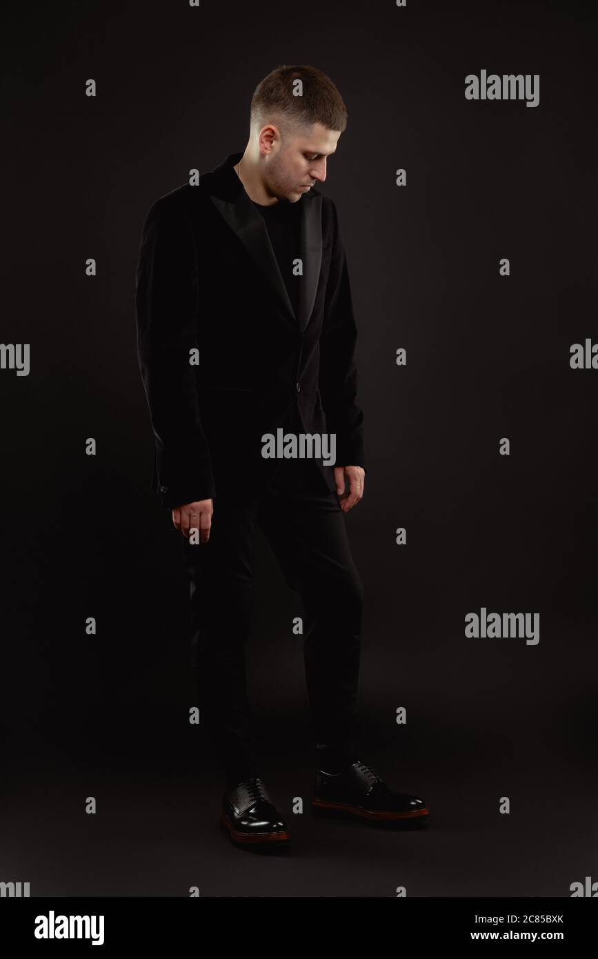 Handsome man in formal suit isolated on black background Stock Photo