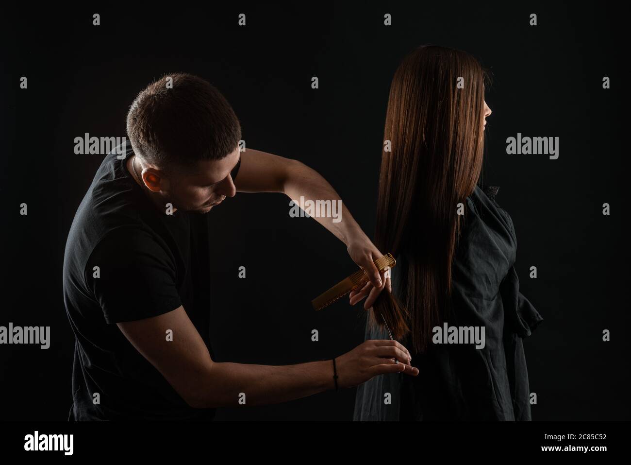 Student Hairdresser Cutting Hair. Hairdresser styling womans hair Stock Photo