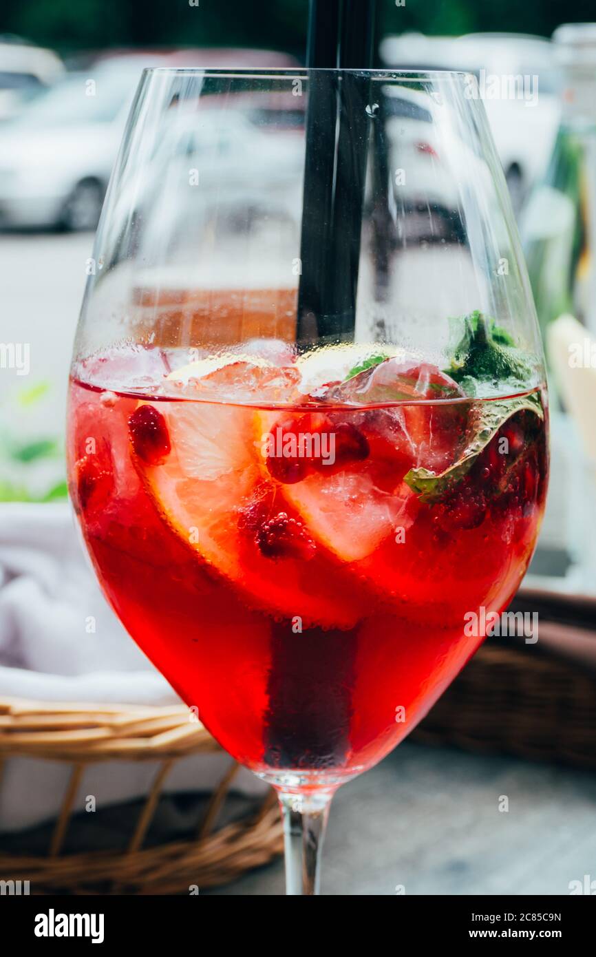 summer cocktail with mint, lemon slices and red berries, Summer