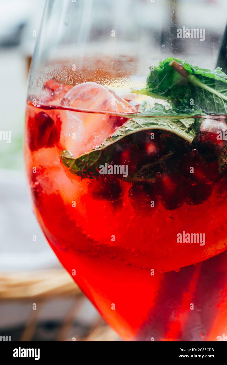 summer cocktail with mint, lemon slices and red berries, Summer