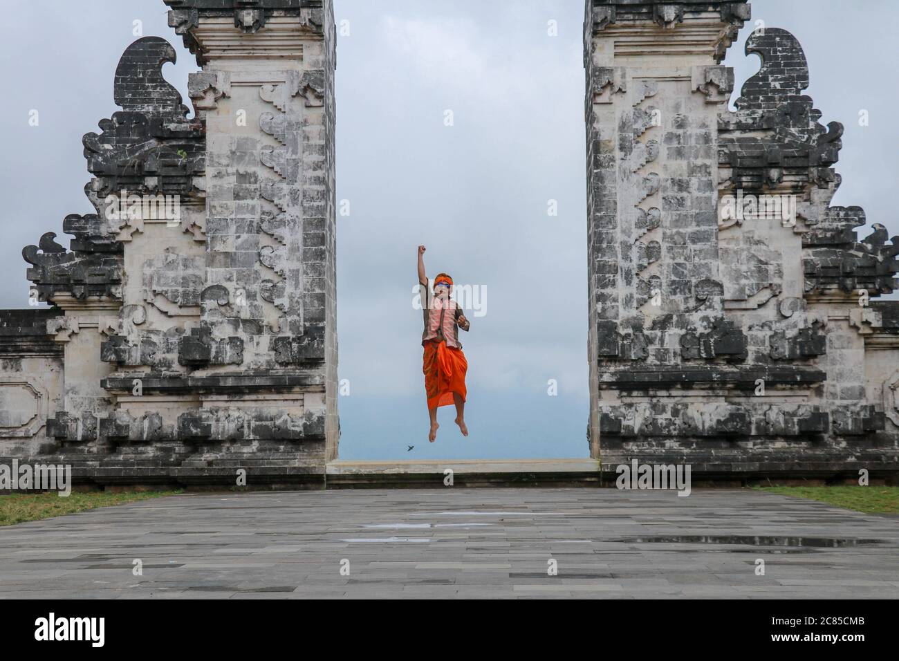 Bali Indonesia Traveler Man Jumping With Energy And Happiness In The Gate Of Heaven Lempuyang Temple Stock Photo Alamy