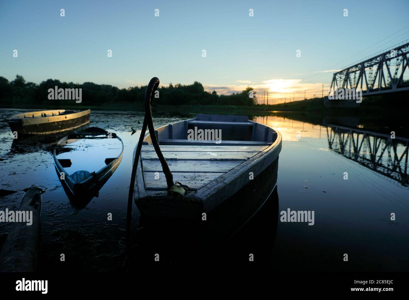old wooden boats stand on the river in the evening Stock Photo - Alamy
