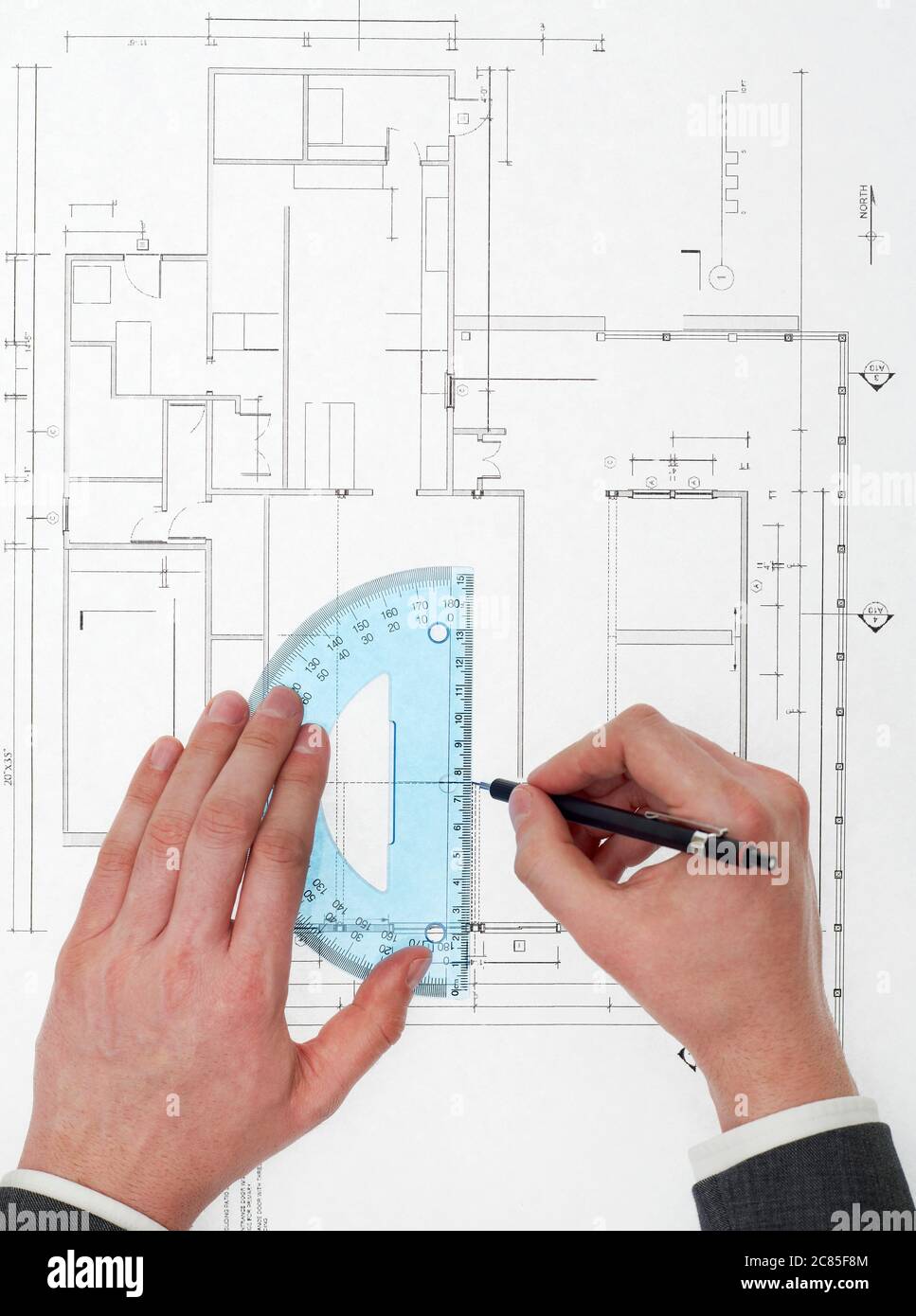 Architect drawing on blueprints Stock Photo