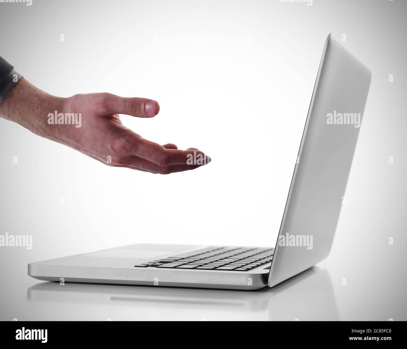 Hand in front on laptop Stock Photo - Alamy