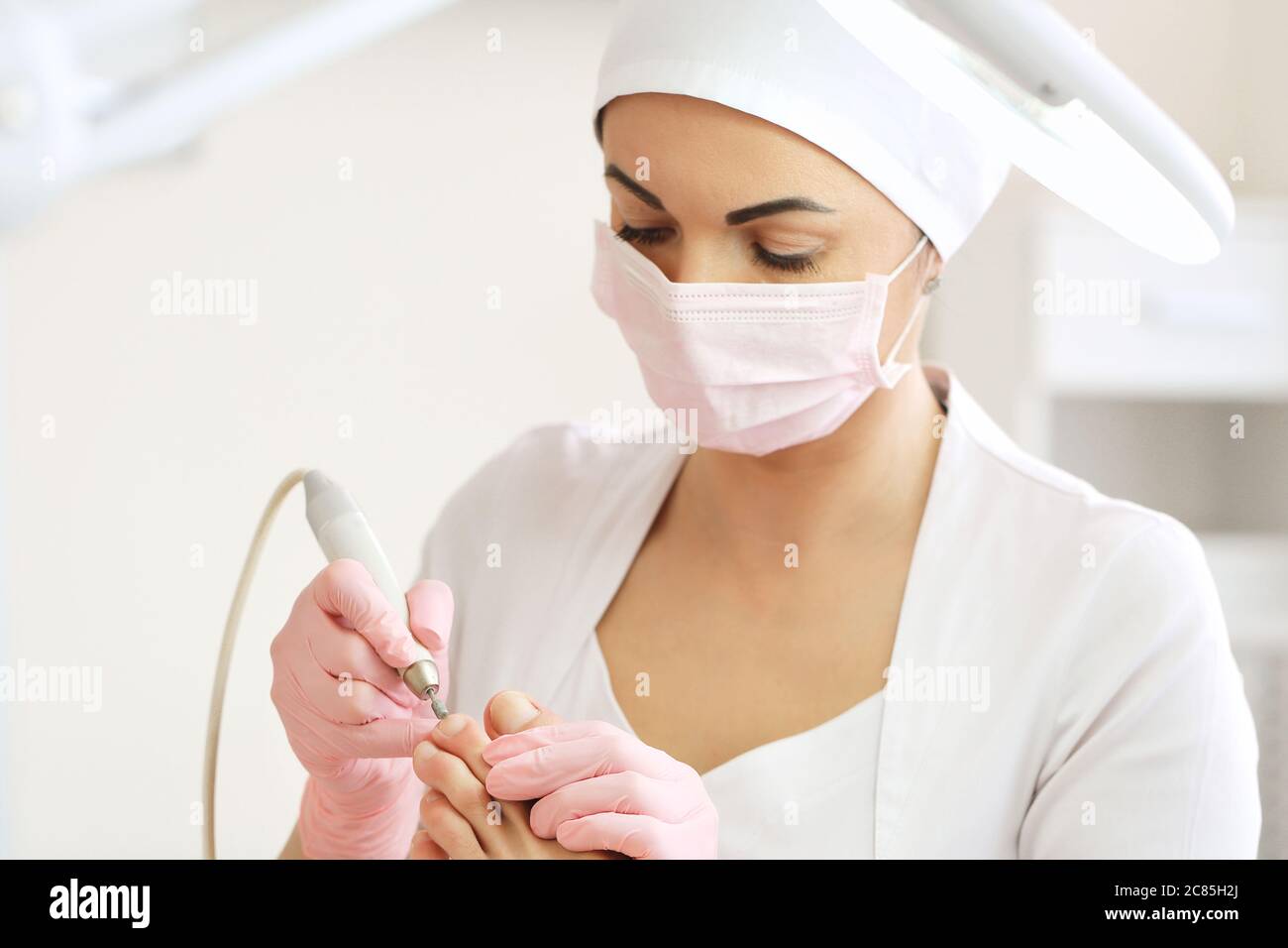 Patient on medical pedicure procedure, visiting podiatrist.Professional