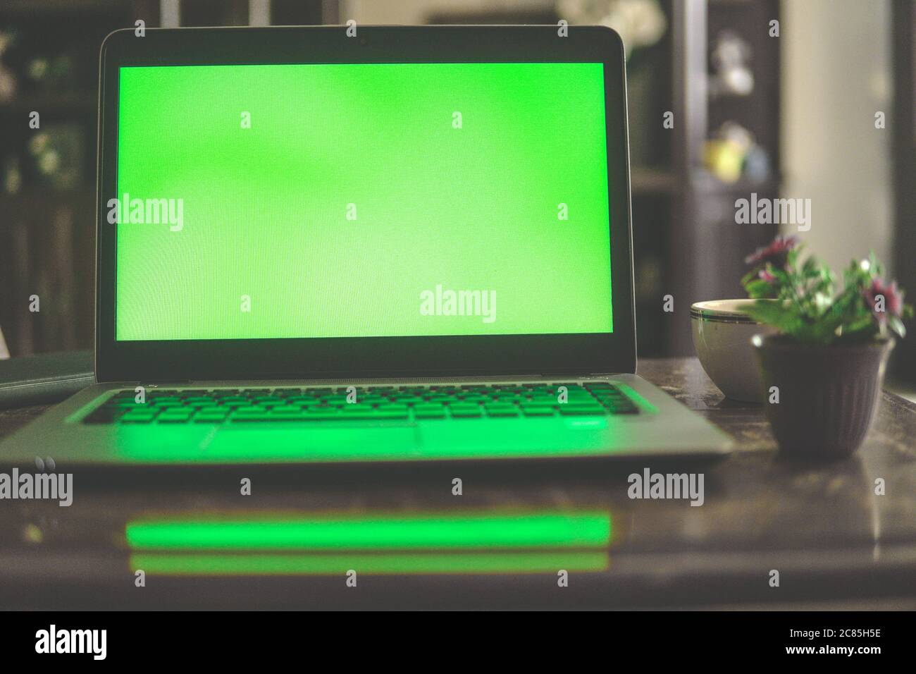 Selective focus shot of a laptop computer showing green chroma key screen Stock Photo