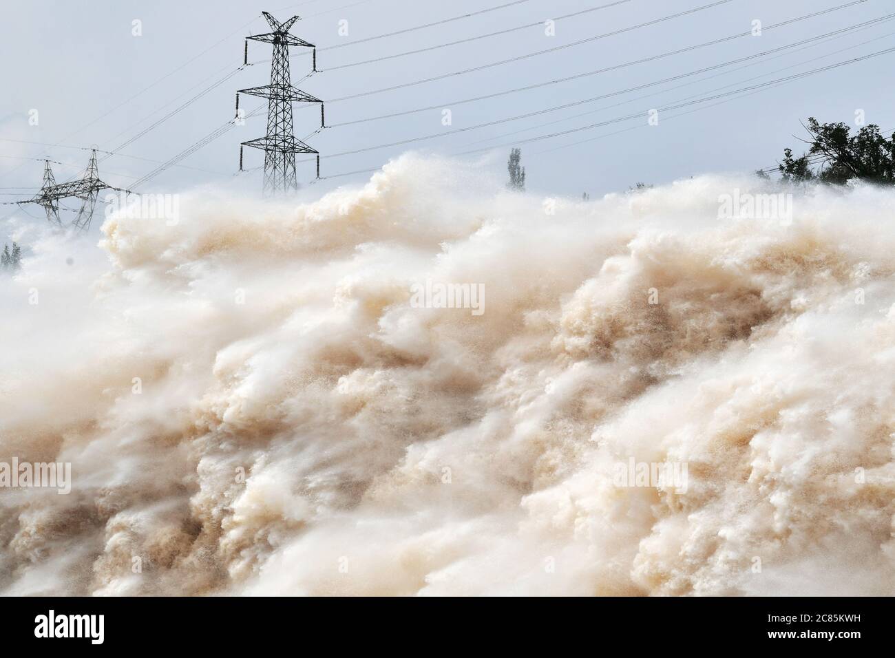 (200721) -- LANZHOU, July 21, 2020 (Xinhua) -- Photo taken on July 21, 2020 shows the Liujiaxia reservoir discharging floodwater in Linxia Hui Autonomous Prefecture, northwest China's Gansu Province. The water flow in the upper stream of the Yellow River has been increasing due to rainfall. The Lanzhou hydrological station saw the second flood of the river this year with the water flow of 3,000 cubic meters per second, which occured at 8:42 p.m. on Monday. Credit: Xinhua/Alamy Live News Stock Photo