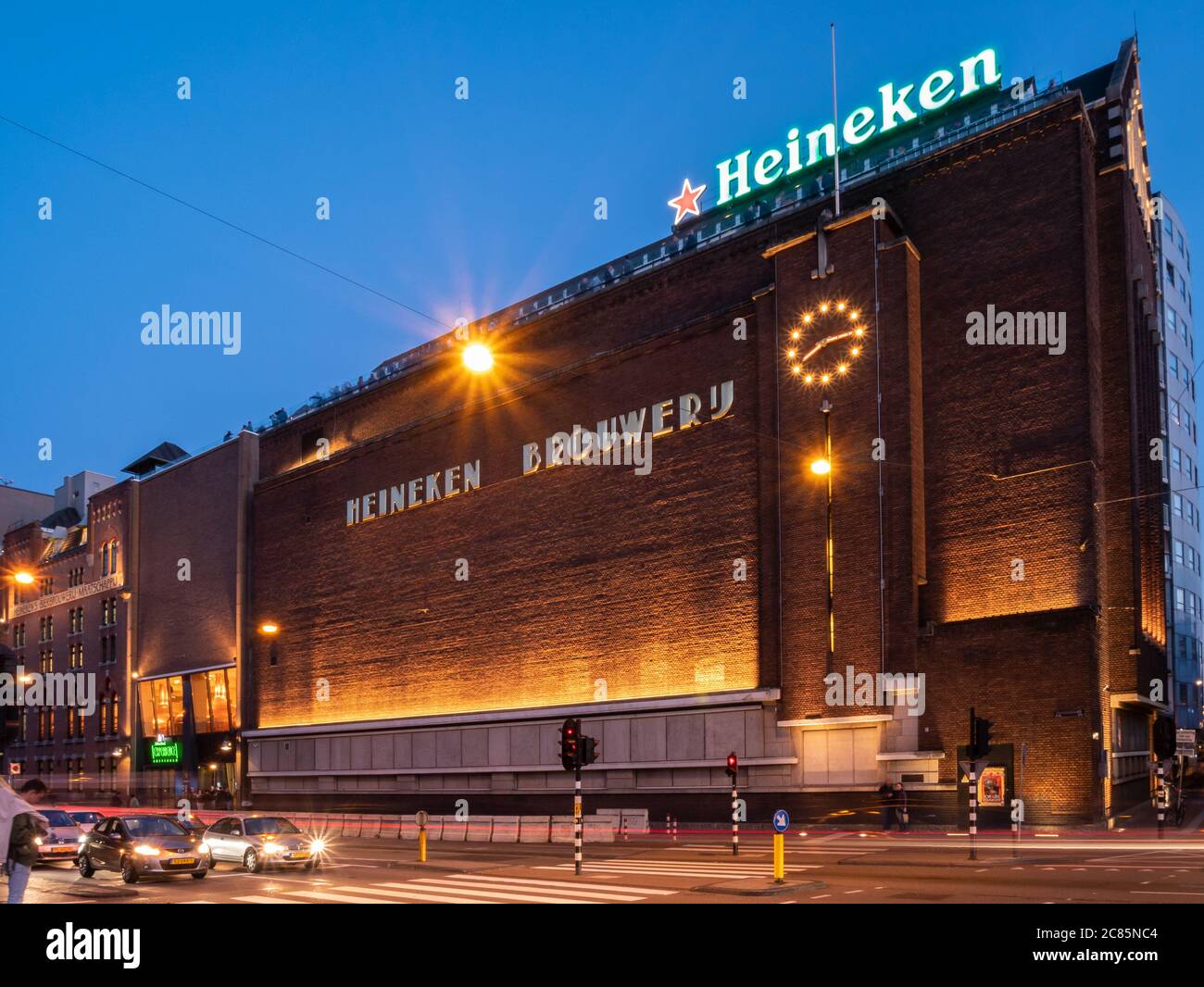 Amsterdam, Netherlands - October 15 2018: Early evening traffic passes by the Heineken Experience in Amsterdam. Stock Photo