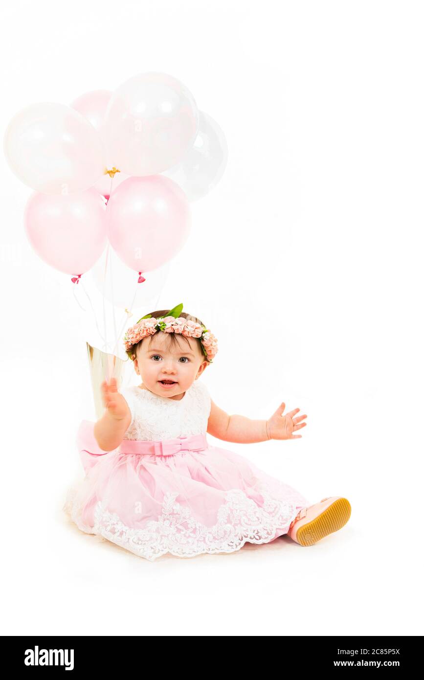 Vertical lifestyle portrait of a baby girl on her first birthday Stock
