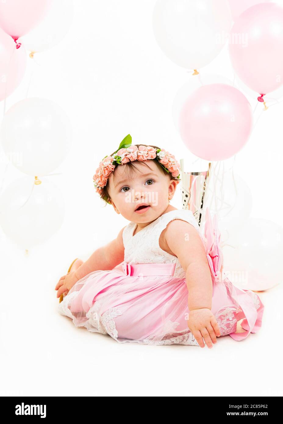 Vertical lifestyle portrait of a baby girl on her first birthday Stock