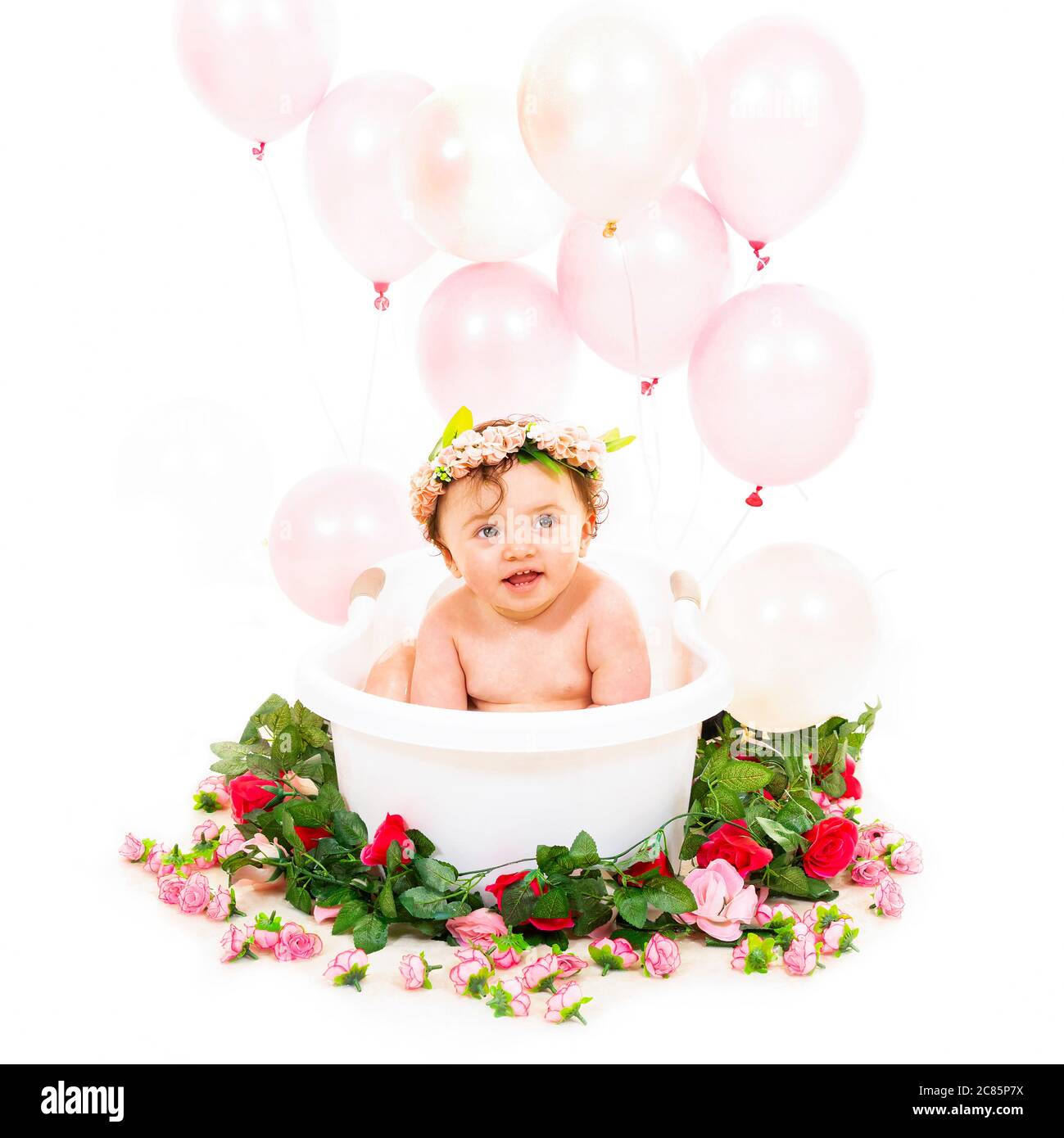 Square lifestyle portrait of a baby girl enjoying bath time. Stock Photo