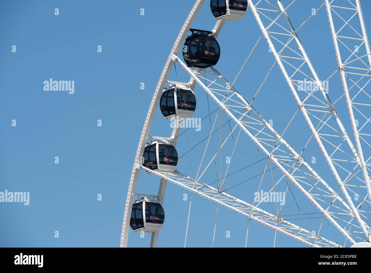 NATIONAL HARBOR, Maryland, United States — A large Ferris Wheel stands on the waterfront at National Harbor in Maryland, on the banks of the Potomac River, directly across from Washington DC. The Ferris Wheel, a popular attraction, offers stunning views of the Potomac and the surrounding areas, including the Washington DC skyline. Stock Photo