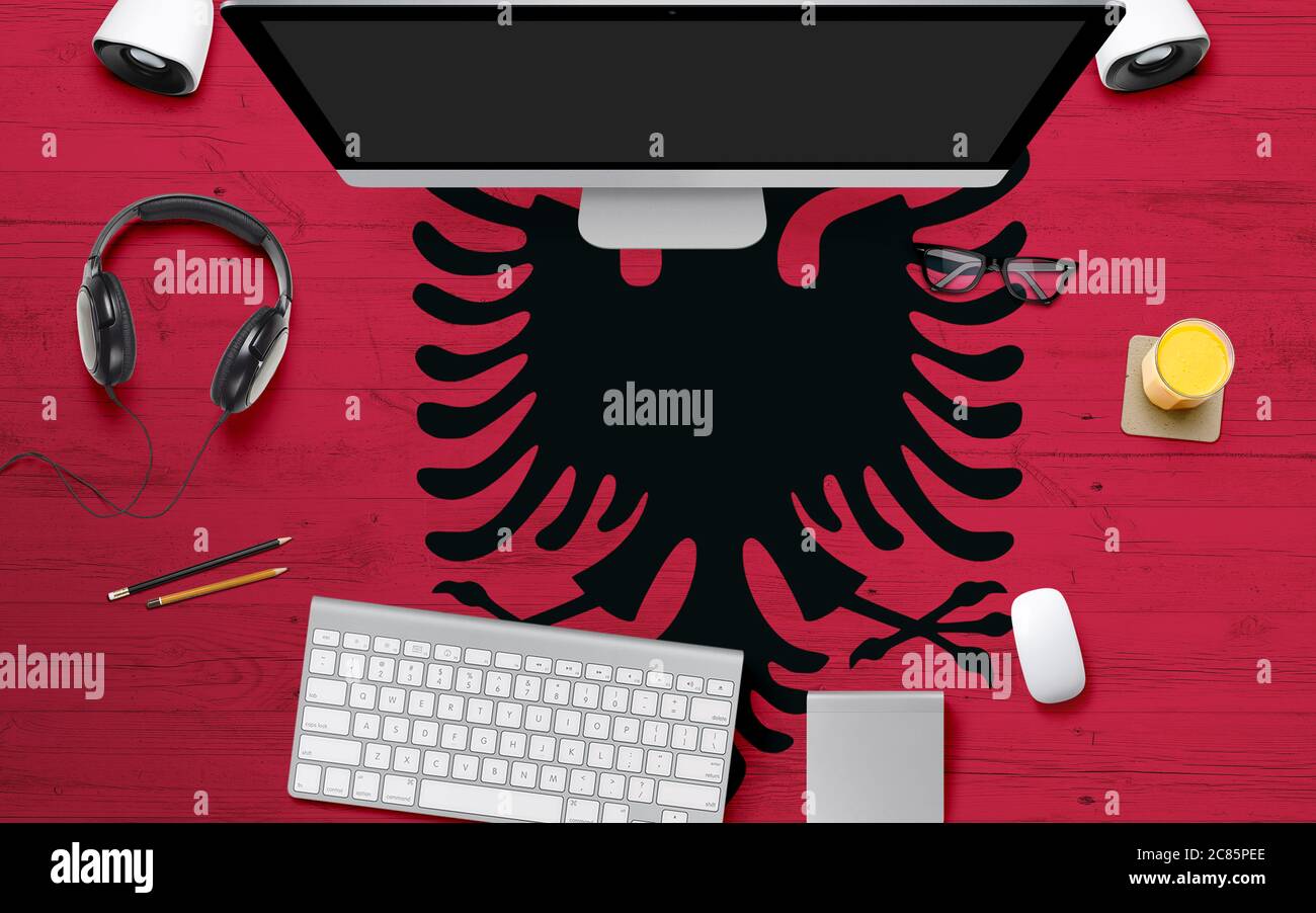 Albania national flag background with workspace, desktop computer and  office accessories on white modern table Stock Photo - Alamy