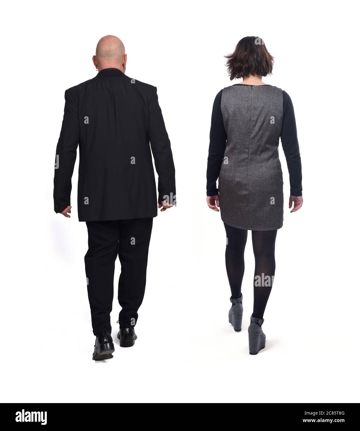 rear view of a elegant couple walking on white background Stock Photo ...
