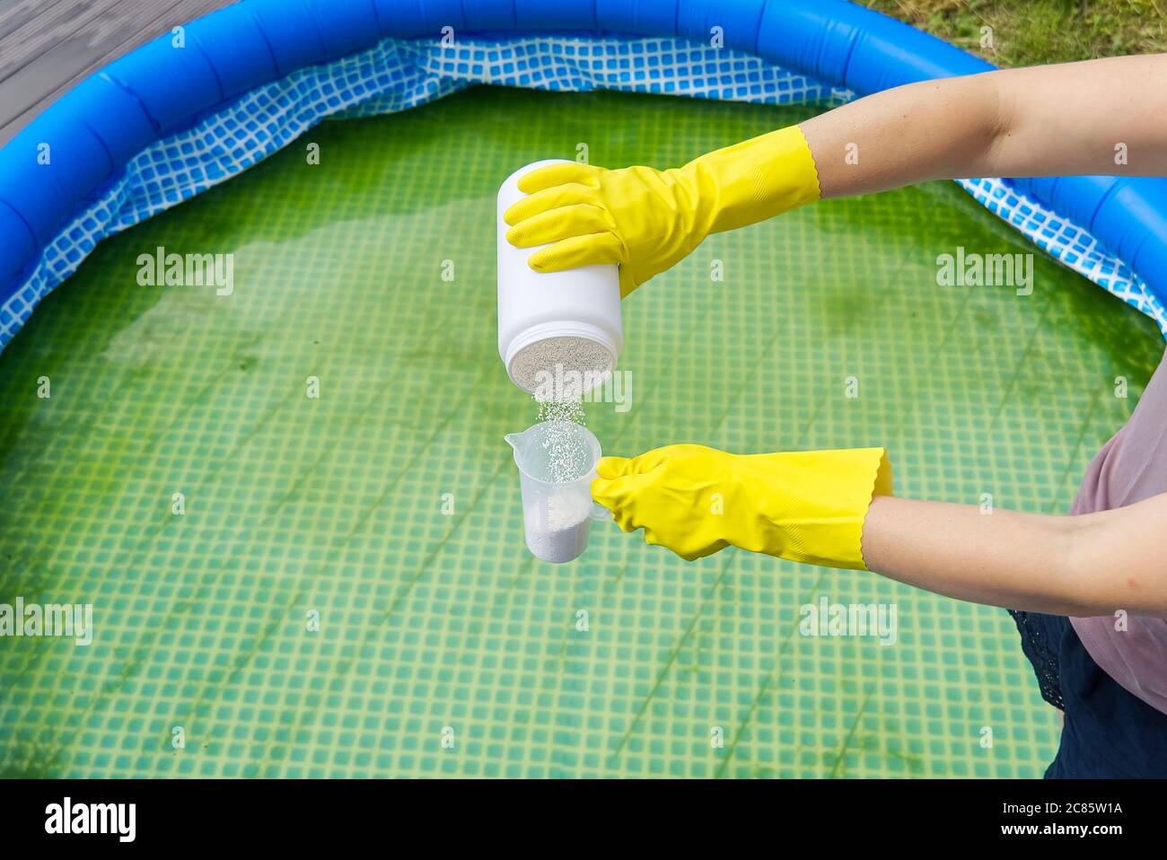 addition of chlorine powder for the pool to remove algae and disinfect