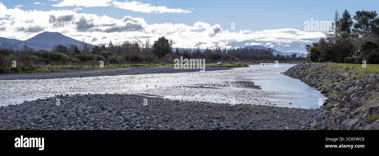 TURANGI, NEW ZEALAND - Aug 25, 2018: Various scenes of the bridge pool of the famous trout filled Tongariro river. 3 Anglers are fly fishing the the b Stock Photo