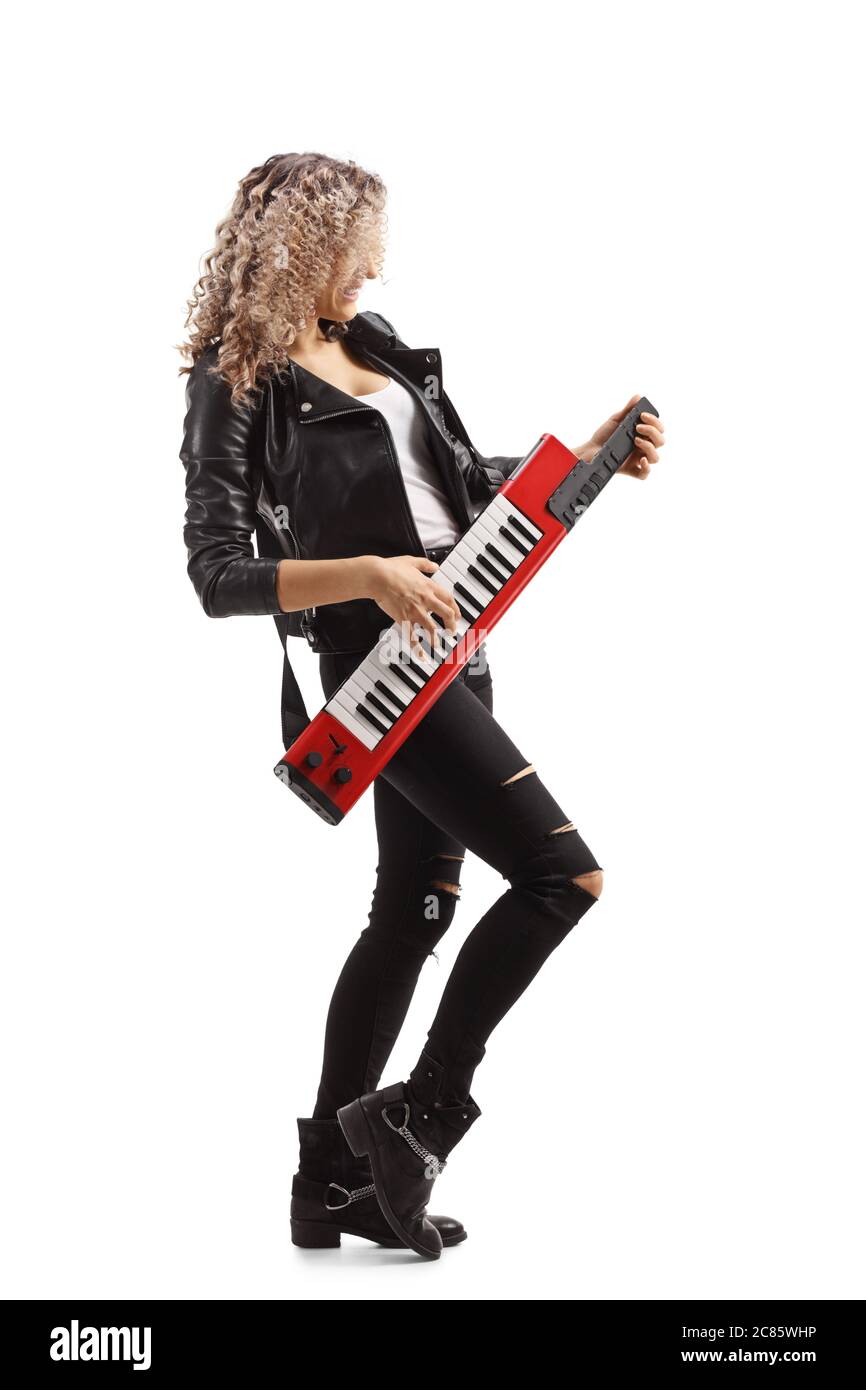 Woman playing a red keytar synthesizer isolated on white background Stock Photo