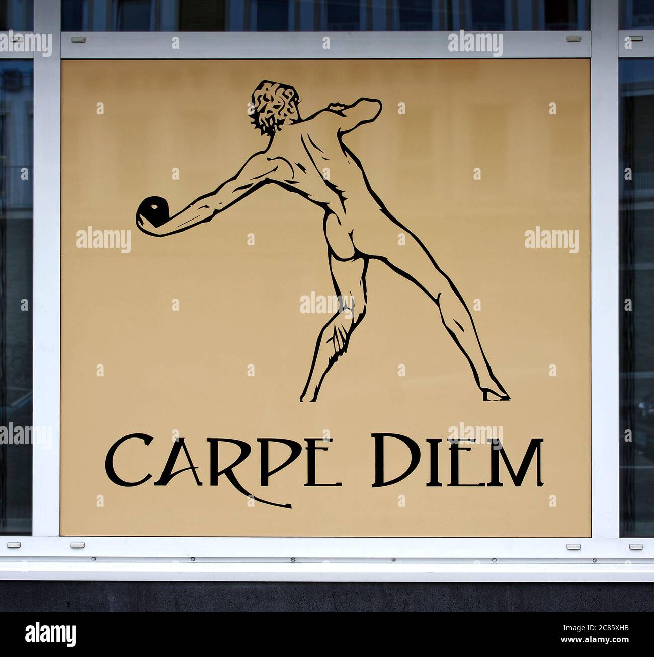 Carpe Diem sign, window, cartoon, drawing, male athlete, Europe, Trier; Germany Stock Photo