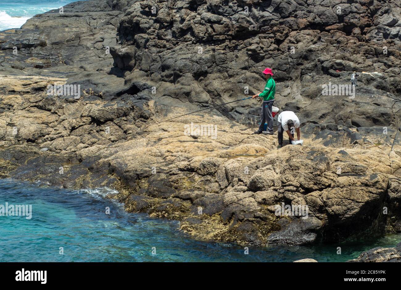 Young male enjoying the mesmerizing beautiful seascape while fishing on ...