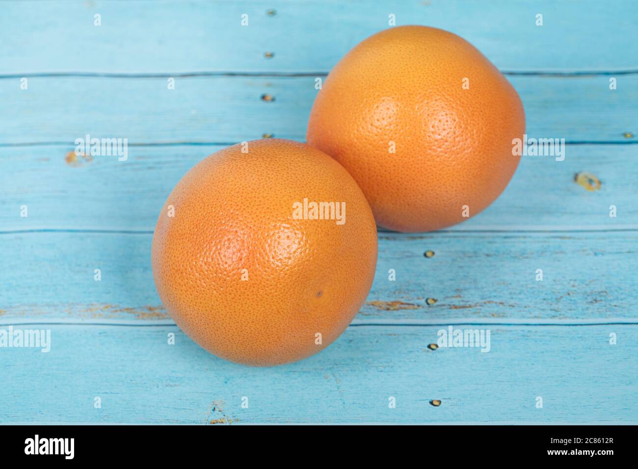 Grapefruits on a rustic blue wooden table Stock Photo