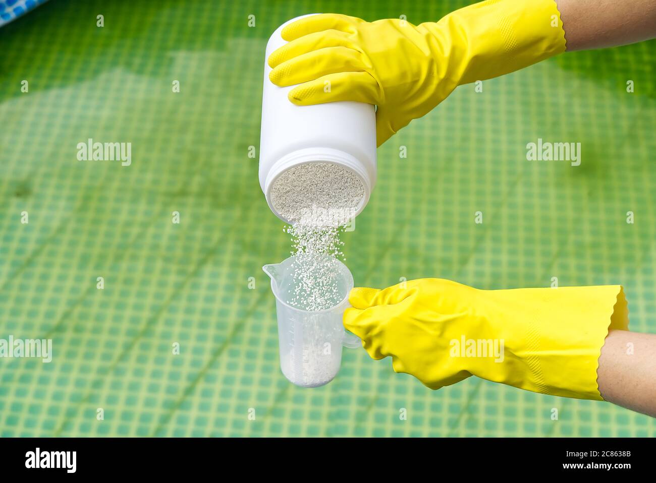 addition of chlorine powder for the pool to remove algae and disinfect