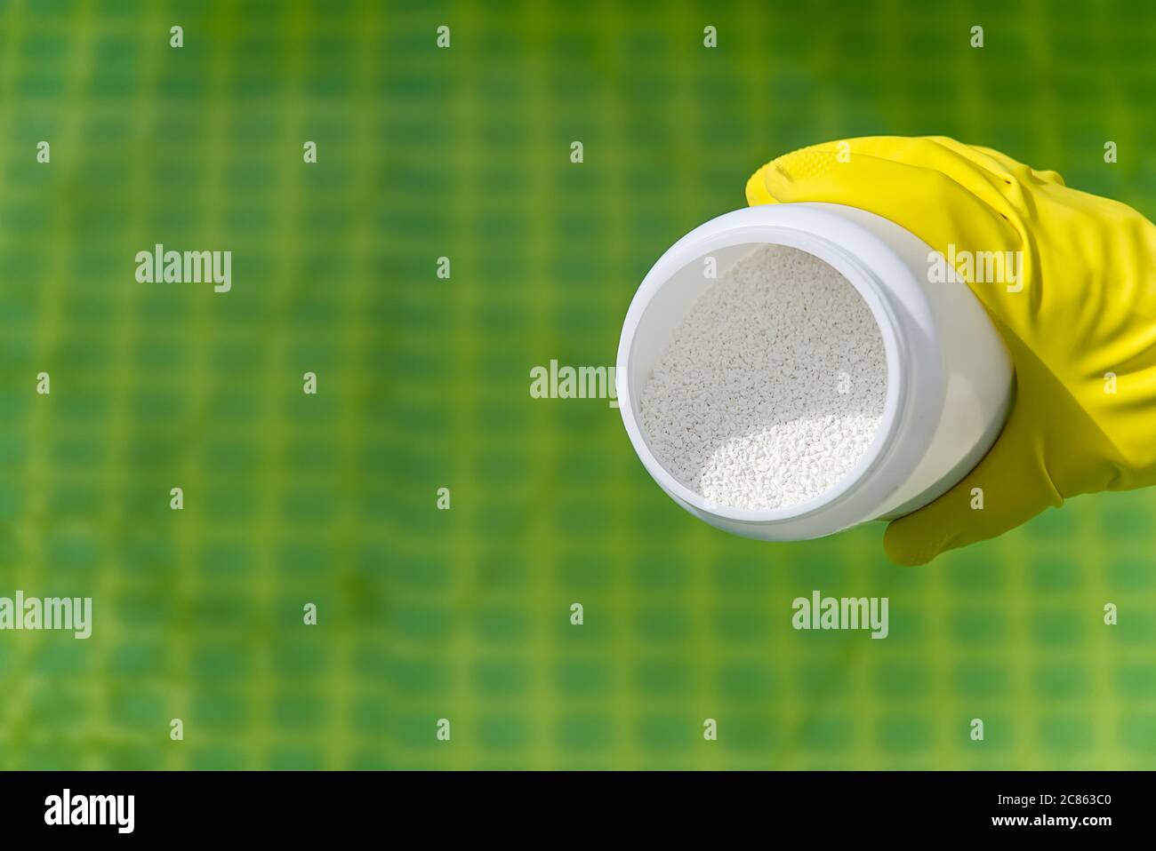 addition of chlorine powder for the pool to remove algae and disinfect