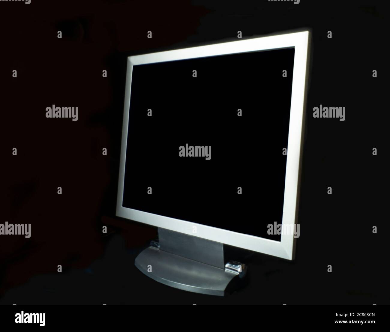 Monitor for computer with white body on black background. Empty display on table Stock Photo