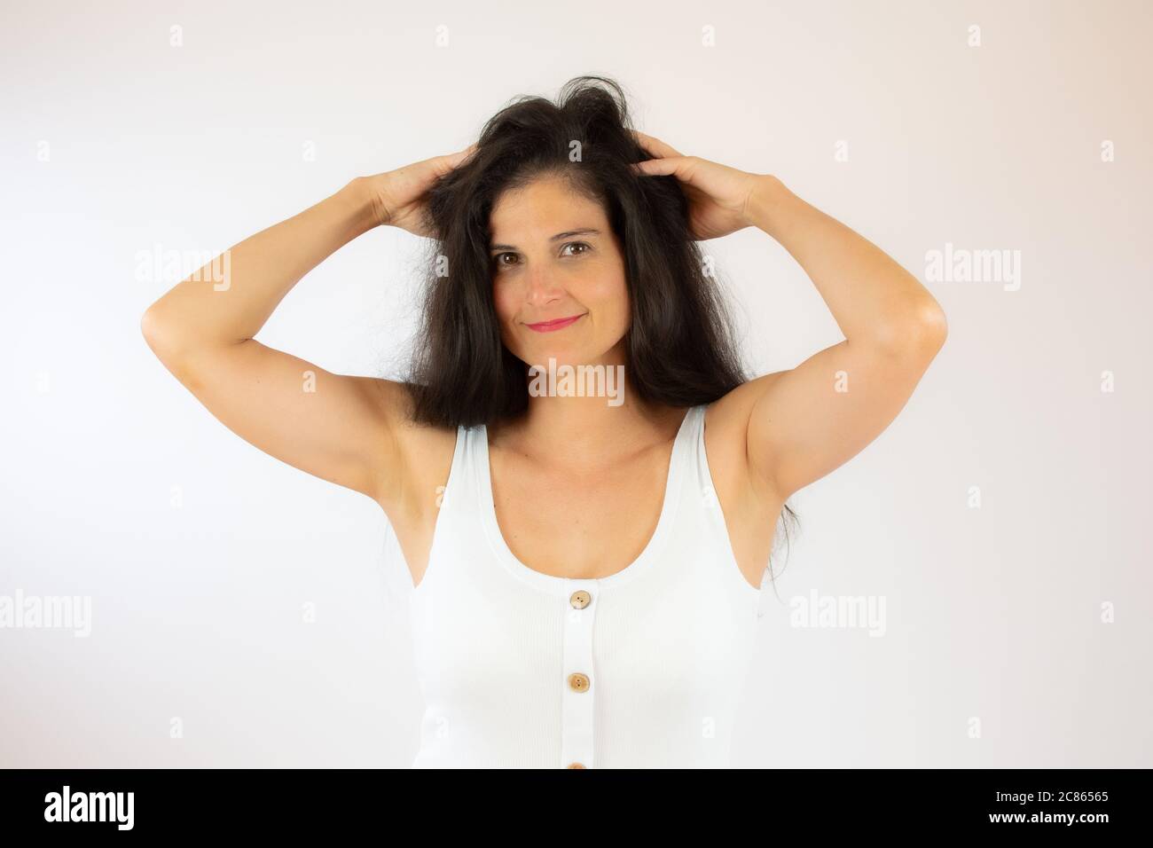 Pretty young woman with long black hair making gesture Stock Photo