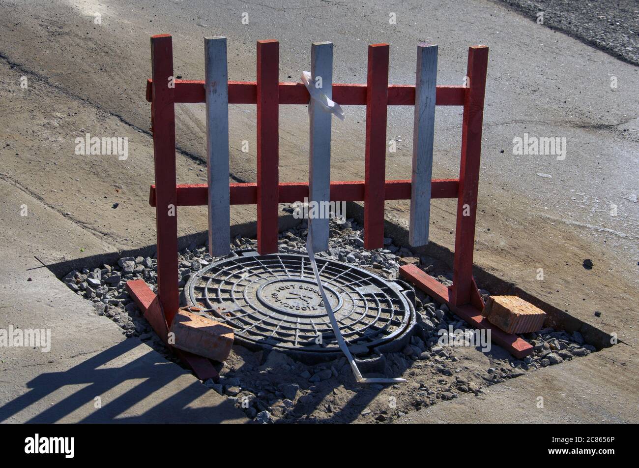 danger fence on the hatch in the city. urban, construction. Stock Photo
