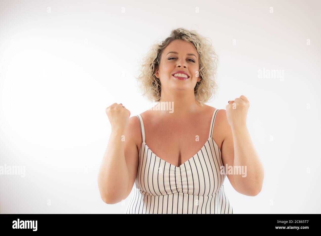Blond woman making winner hi-res stock photography and images - Alamy