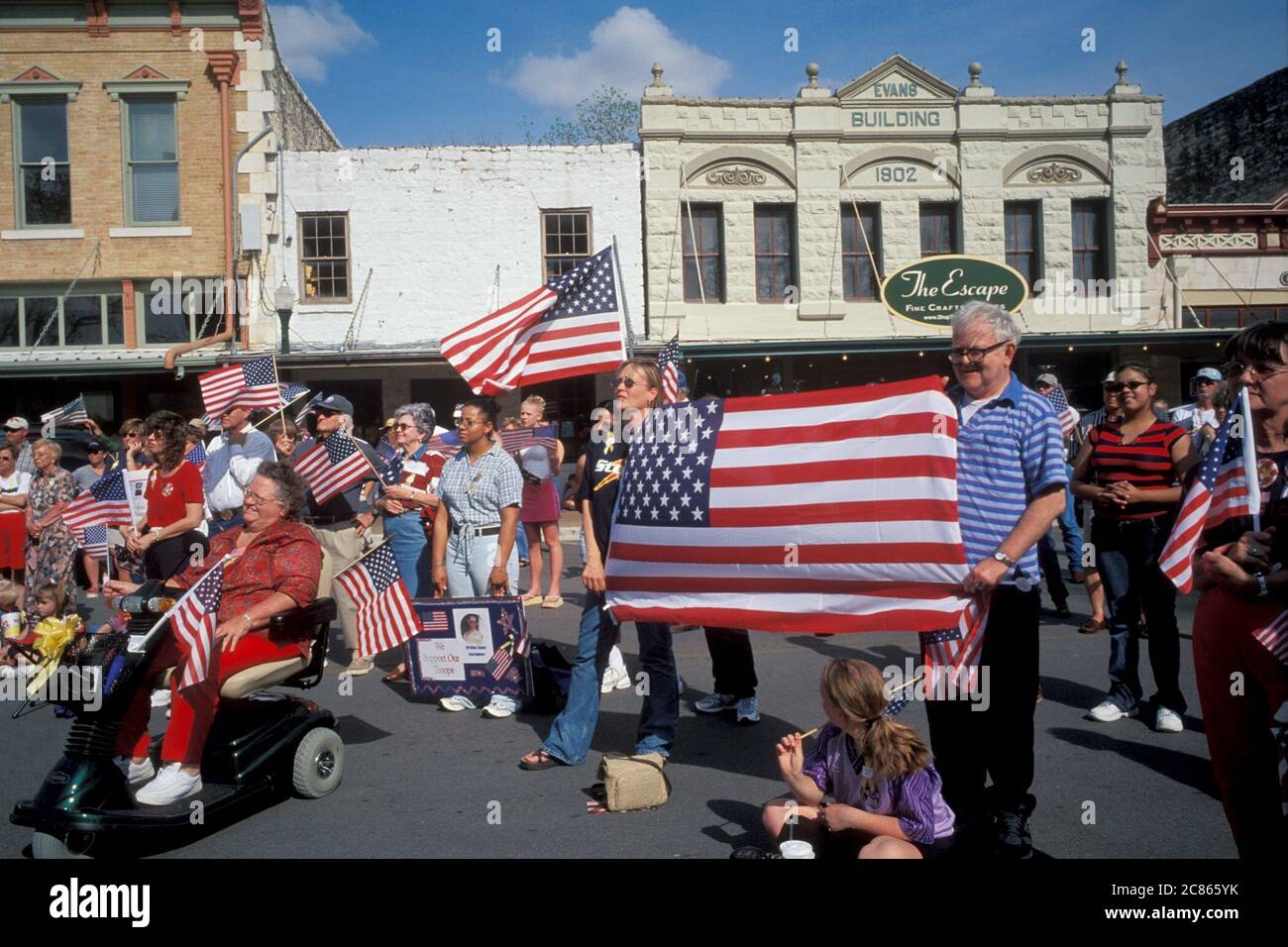 Georgetown, Texas USA, April 2003: American-flag-waving crowd  attends 'Support the Troops' rally in downtown during the war in Iraq. ©Bob Daemmrich Stock Photo