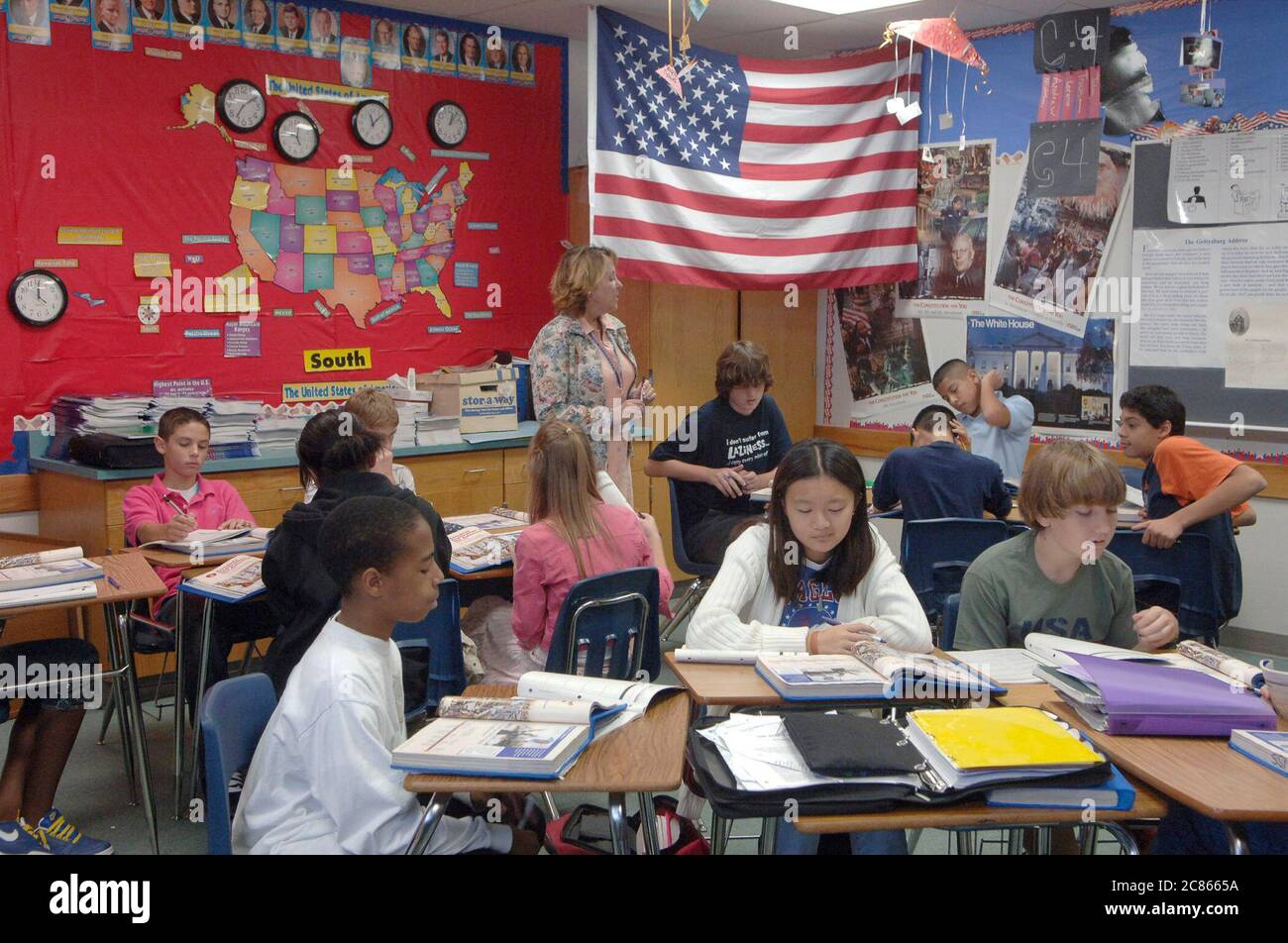 Pflugerville, Texas USA, November 2005: Teacher stands in front of room during seventh grade social studies class in suburban school district outside of Austin. ©Bob Daemmrich Stock Photo
