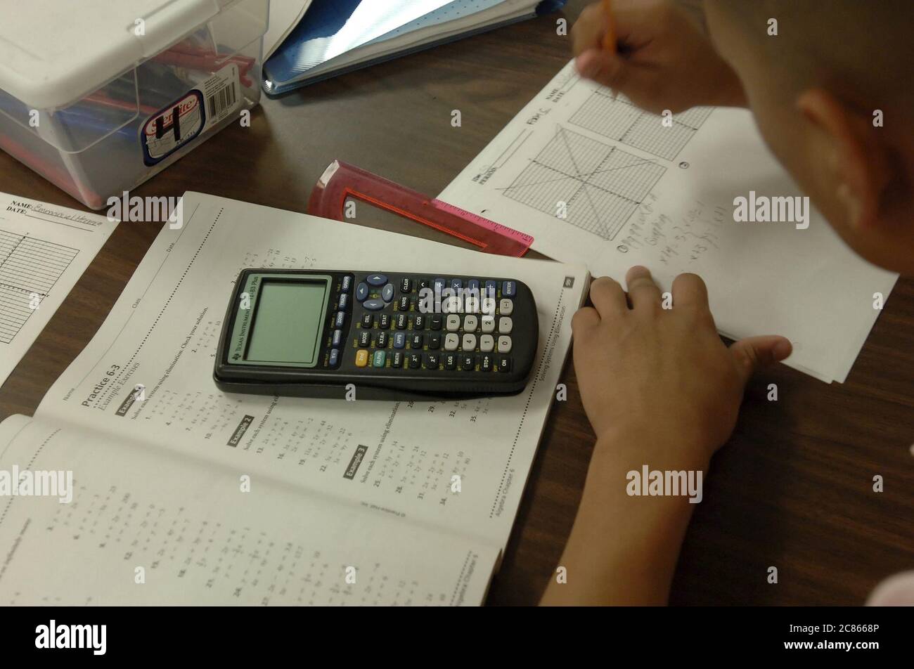 Brownsville, Texas USA, December 2 2005: Student at Lopez High School works on math problems in Algebra II classroom using hand-held scientific calculator. ©Bob Daemmrich Stock Photo