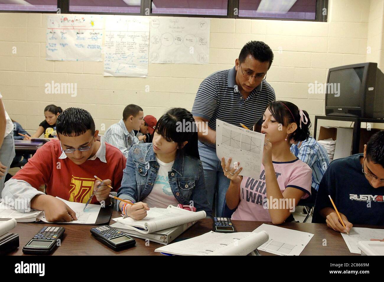 Brownsville, Texas USA, December 2 2005: Students at Lopez High School working on math problems in Algebra II classroom using hand-held scientific calculators. The student population of Lopez HS is over 99% Hispanic.  ©Bob Daemmrich Stock Photo