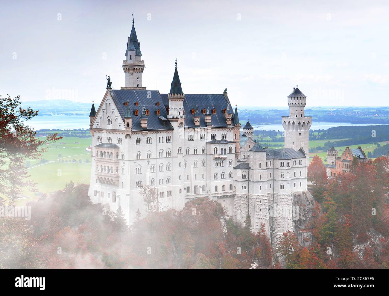Neuschwanstein Castle or Schloss Neuschwanstein in foggy autumn day in southwest Bavaria, Germany Stock Photo