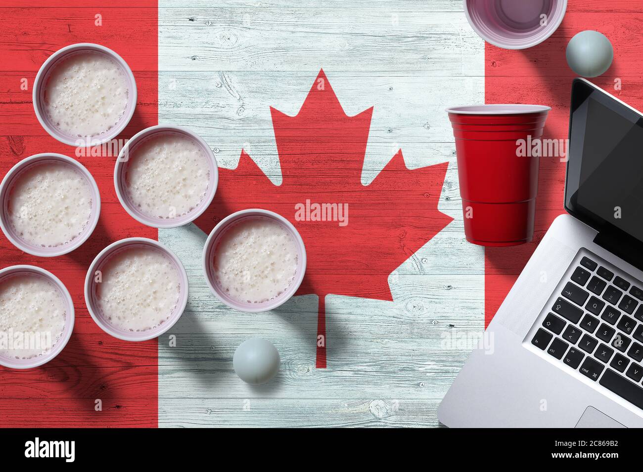 Canada flag concept with plastic beer pong cups and laptop on national  wooden table, top view. Beer Pong game Stock Photo - Alamy